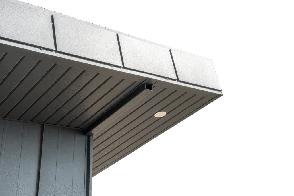 Close-up view of a modern building’s roof overhang with metal fascia and soffit panels, showing a recessed light and small drainage pipe—ideal for those looking to repair fascia and soffit.